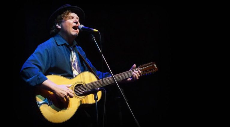 Catfish Keith with guitar onstage