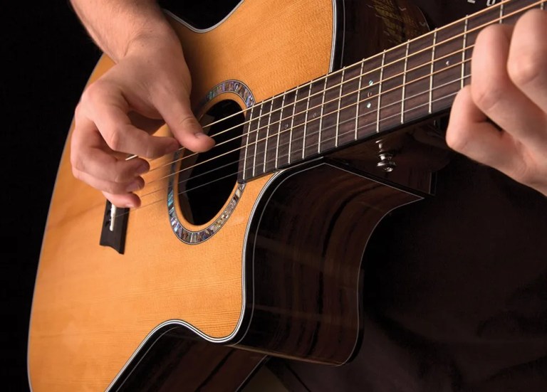 closeup of acoustic guitarist playing fingerstyle