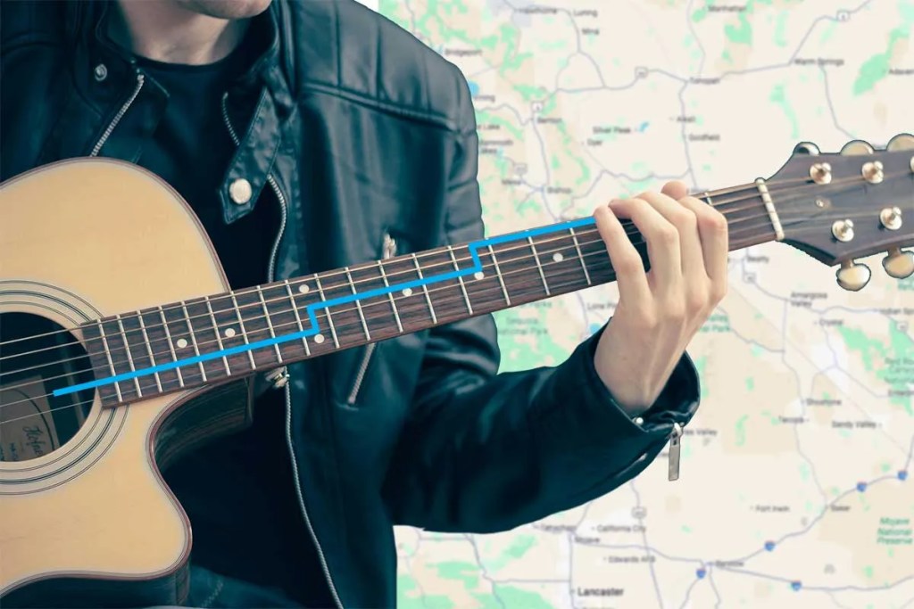 acoustic guitar player with a GPS-like blue line overlaid on the fretboard and a map background