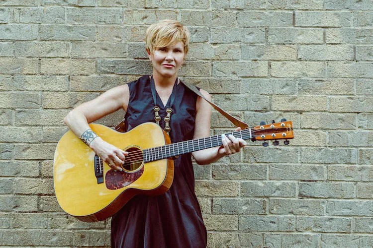 Singer-songwriter Shawn Colvin playing an acoustic guitar.