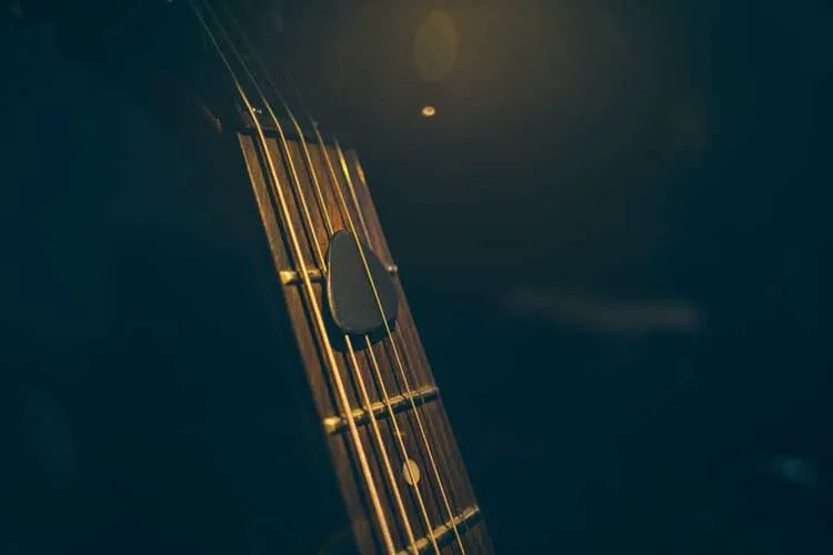 pick and guitar fretboard